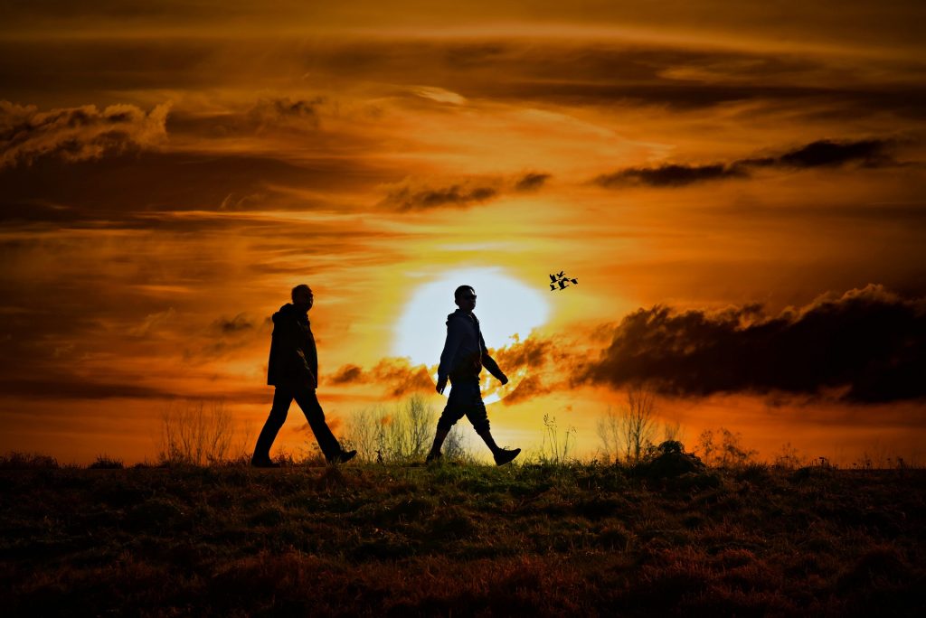 People walking at sunset